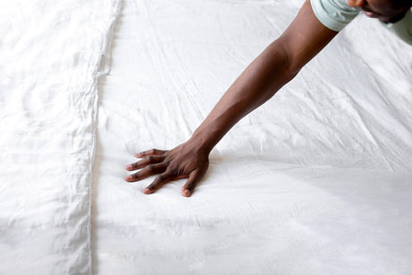 Blog banner of blog How to Measure Mattress Indentation & Sagging: Quick NZ Guide showing a person keeping a hand on a mattress to feel it.