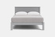 A modern light gray wooden bed frame with a low headboard and matching footboard, styled with white bedding and two white pillows against a plain white background.