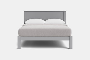 A modern light gray wooden bed frame with a low headboard and matching footboard, styled with white bedding and two white pillows against a plain white background.