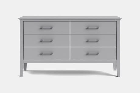 A light gray wooden dresser with six drawers and silver metal handles, shown against a plain light gray background.
